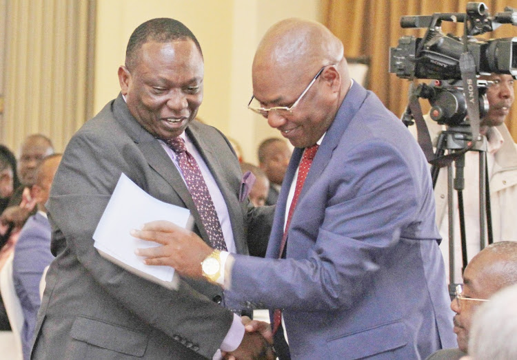 Kenya National Chambers of Commerce President Richard Ngatia with Livestock PS Harry Kimtai during a round table meeting with Kenya Exporters at Movenpick Hotel in Nairobi on July 27,2022